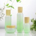 High-grade Cosmetic Gradient green glass bottles/jars with wood grain cap